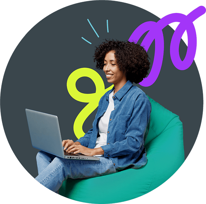 Smiling young woman with curly hair sits on a turquoise bean bag, working on a laptop. She wears a denim jacket and jeans, with colorful abstract squiggles in the background.
